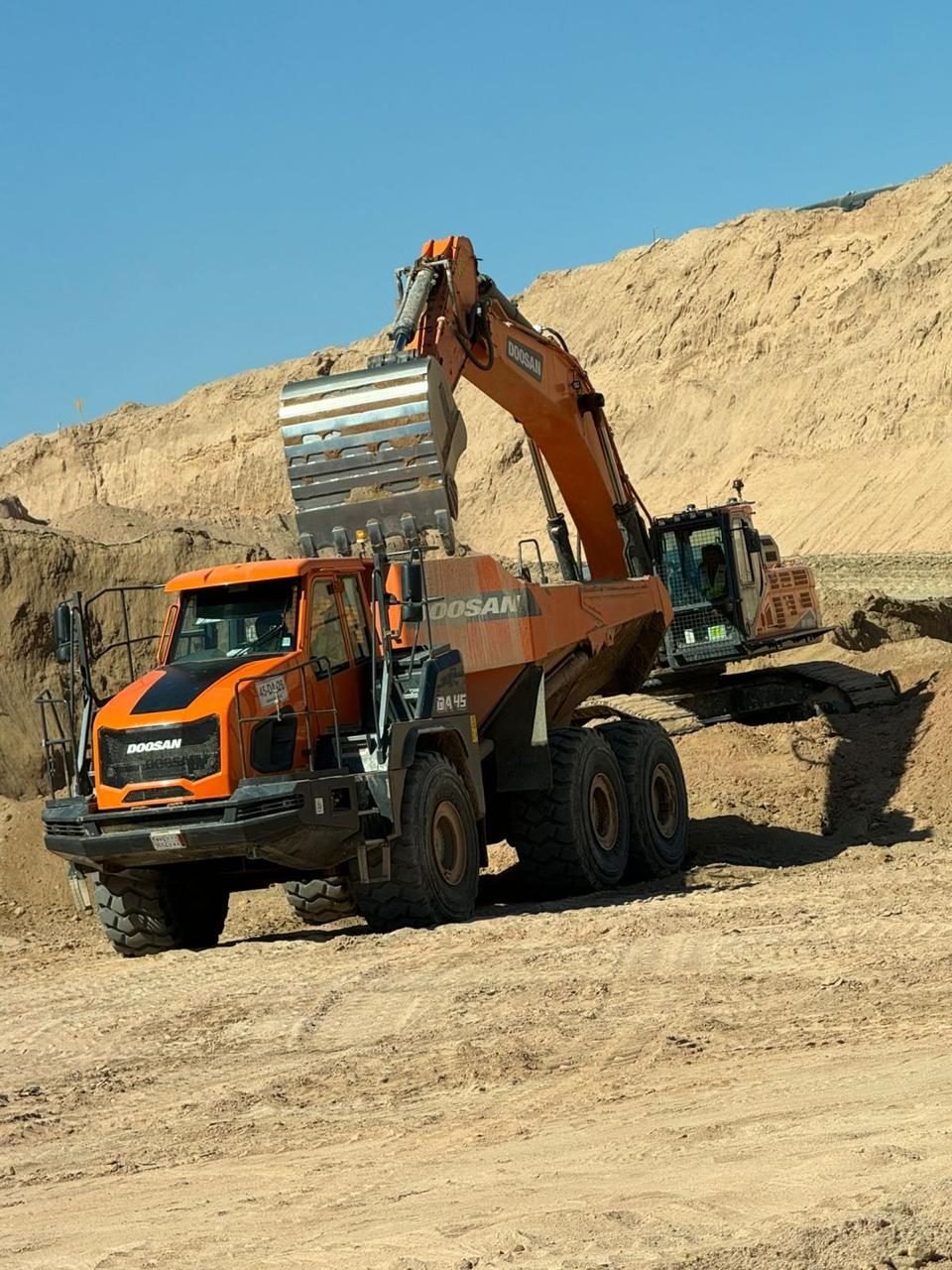 Excavator and articulated dumper